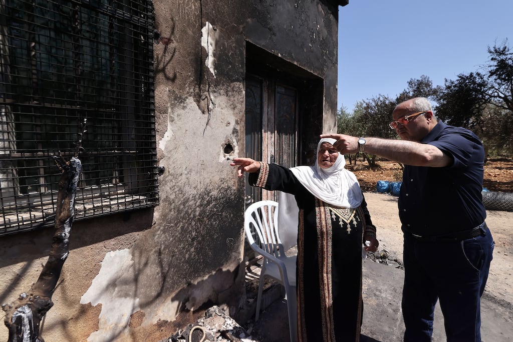 Arab-Israeli Knesset member Ahmed Tibi speaks with a house owner at the site of an attack by Israeli settlers on the village of Turmus Ayya near the occupied West Bank city of Ramallah on June 24th, 2023. Photograph: AHMAD GHARABLI/AFP via Getty Images