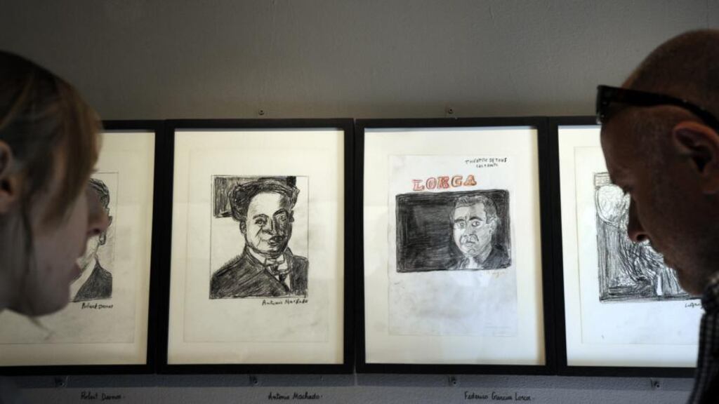 People look at drawings of  Antonio Machado and Federico Garcia Lorca – their fate during the Spanish Civil War has been glossed over in a school book. Photograph: Anne-Christine Poujoulat/AFP/Getty
