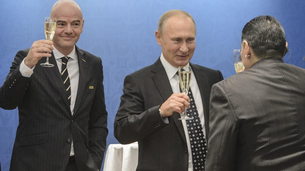 Fifa president Gianni Infantino enjoys a glass of champagne with Russian president Vladimir Putin and Diego Maradona. Photo: Getty Images