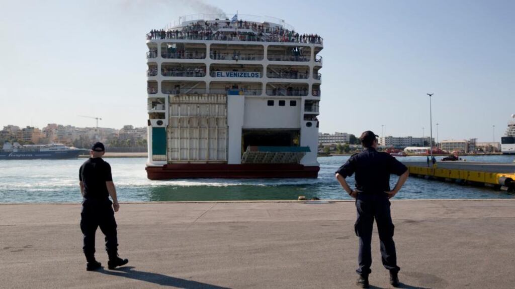 Greek coastguard officers watch ferry carrying about 2,500 migrants from Greek islands as it arrives in Piraeus, near Athens. Photograph: AP Photo/Petros Giannakouris