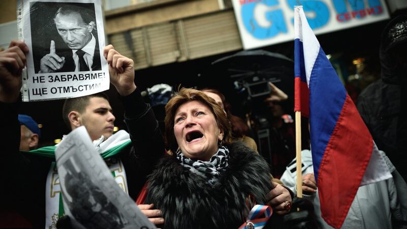 A woman cries as she holds a portrait of fallen Russian pilot during a protest in front of the Turkish embassy in Sofia, Bulgaria on Thursday. Photograph: Vassil Donev/ EPA