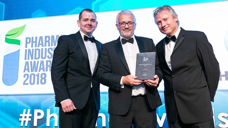 Paul Leamy, CTO, Perigord Life Science Artwork Solutions presents the Supply Chain Achievement Award to CraigButler & MichaelButler, Optel Group.