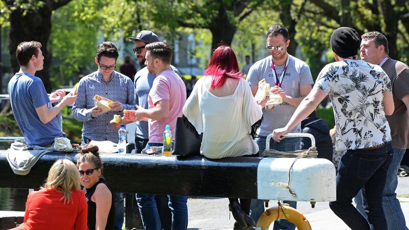 City dwellers relax in the sunshine along the banks of the Grand Canal at Baggot Street bridge in Dublin. Photograph: Eric Luke/The Irish Times