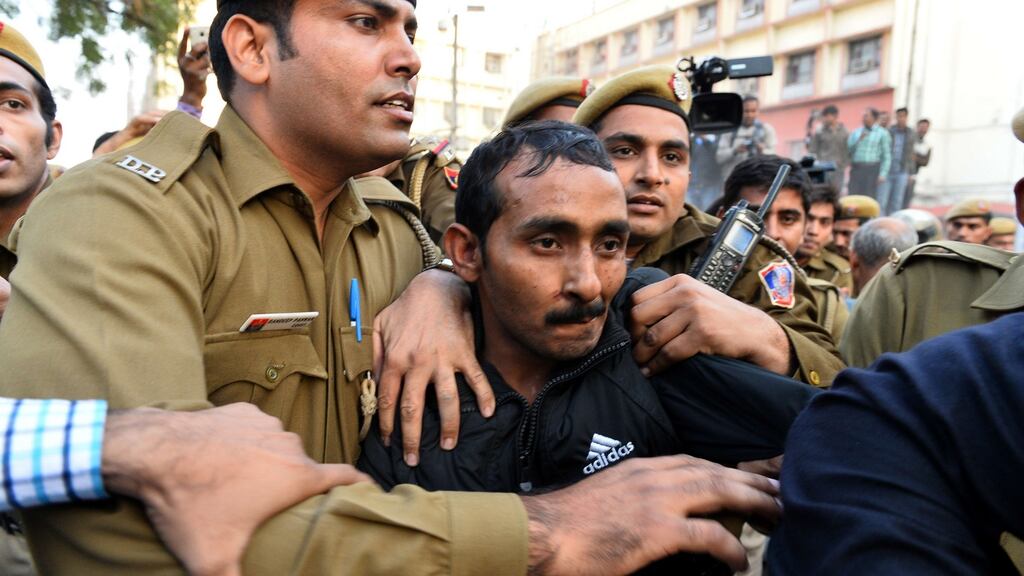 In this file photograph, Indian police escort Uber taxi driver and now convicted rapist Shiv Kumar Yadav after a court appearance in Delhi. Photograph: Chandan Khanna/AFP/Getty Images