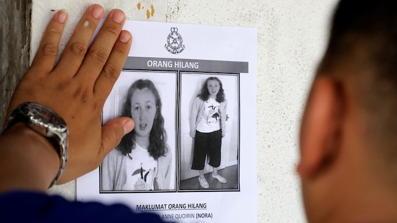 A police officer pastes a photo of missing 15-year-old Irish girl Nora Quoirin on a wall at a shop in Seremban, Malaysia, August 9th, 2019. Photograph: Lim Huey Teng/Reuters