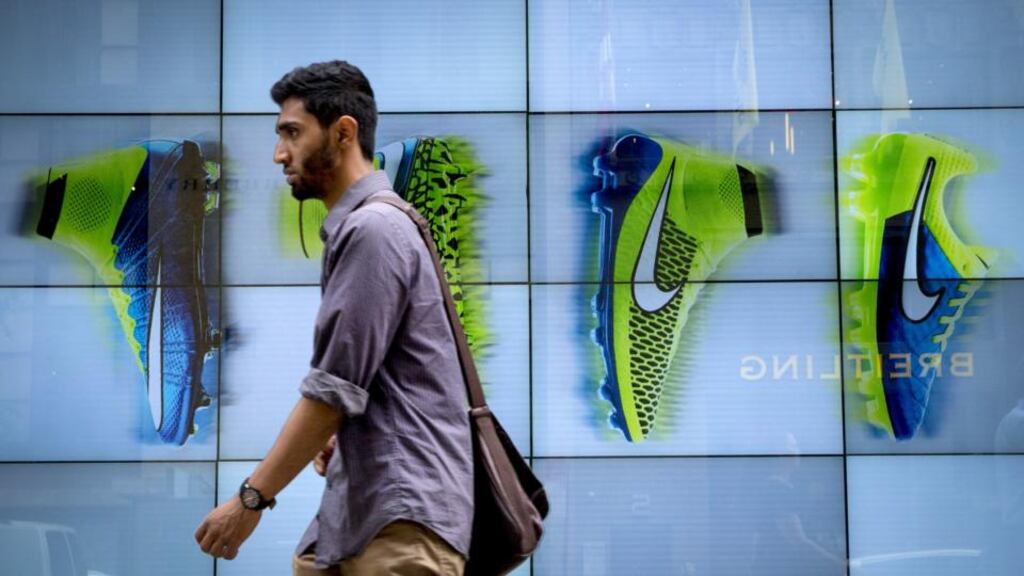 A man passes by the Niketown store in midtown Manhattan. The company’s net income rose 24 per cent to $865 million