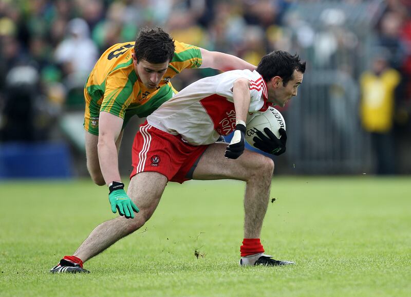 Donegal's Patrick McBrearty with Eugene Scullion of Derry in 2012. Photograph: Dan Sheridan/Inpho