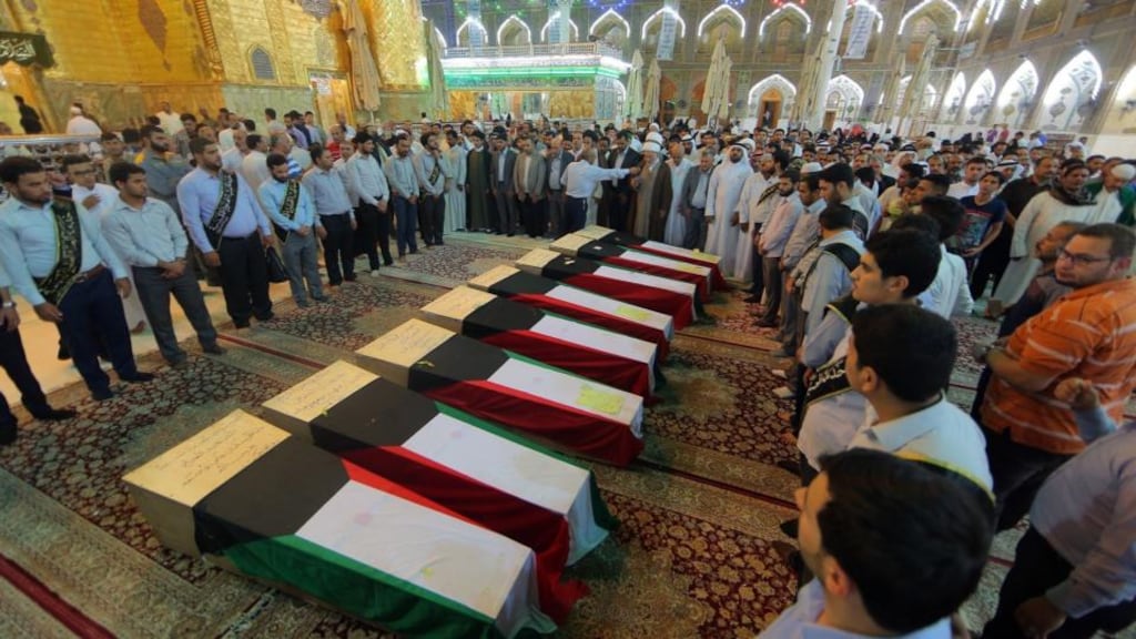 Coffins draped with Kuwaiti flags belonging to victims of the Kuwaiti Shia mosque bombing, which have been brought to Najaf, Iraq, for burial. Photograph: jaber al-helo/AP/