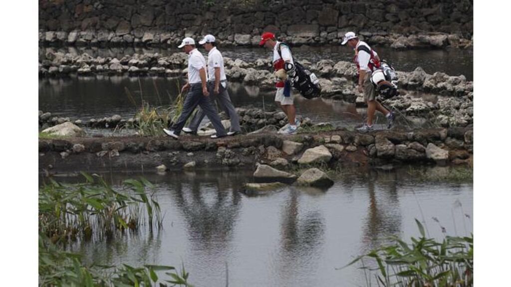 Graeme McDowell (left) of Ireland and teammate Rory McIlroy (second left) walk to the 18th fairway during the third round of the Mission Hills World Cup in Haikou, China's Hainan province November 26th, 2011. - (Photograph: Bobby Yip/Reuters)