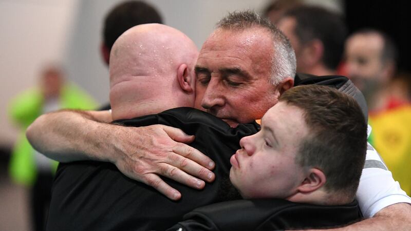 Team Ireland’s Richard Moran, from Crosshaven, Co Cork, and Lorcan Byrne, from Ballyfermot, Dublin, are comforted by coach Michael Lynch after a 4-3 defeat to Germany. Photograph: Ray McManus/Sportsfile