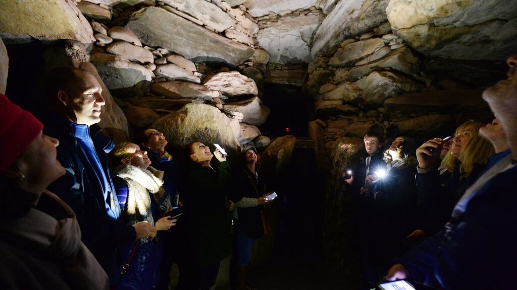 Lucky Winter Solstice lottery winners in the chamber at Newgrange.  Photograph: Alan Betson/The Irish Times