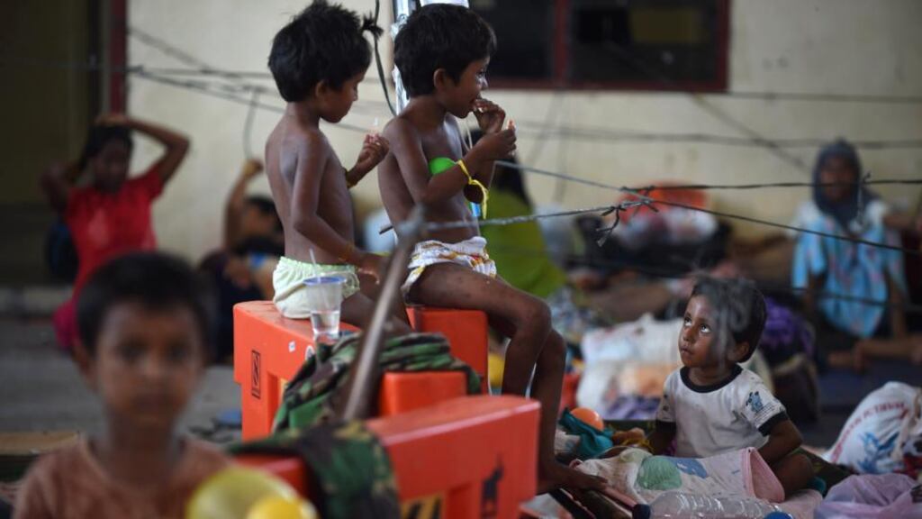 Migrant Rohingya children from Burma rest with their family at the confinement area in the fishing port of Kuala Langsa in Indonesia where hundreds of migrants from Burma and Bangladesh are taking temporary shelter after they were rescued by Indonesian fishermen. Photograph: Romeo Gacadromeo/AFP/Getty Images