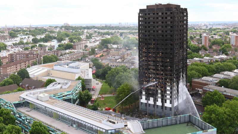 Water being sprayed onto Grenfell Tower in west London after a major fire engulfed the 24-storey building in June, leaving scores dead. Photograph: Rick Findler/PA Wire