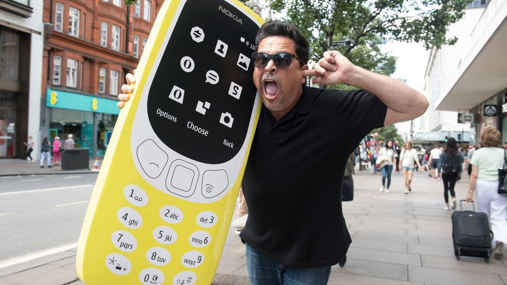 “Yeah, it’s rubbish!”: Comedian Dom Joly reunites with a Nokia 3310 on London’s Oxford Street. Photograph: Victoria Jones/PA Wire