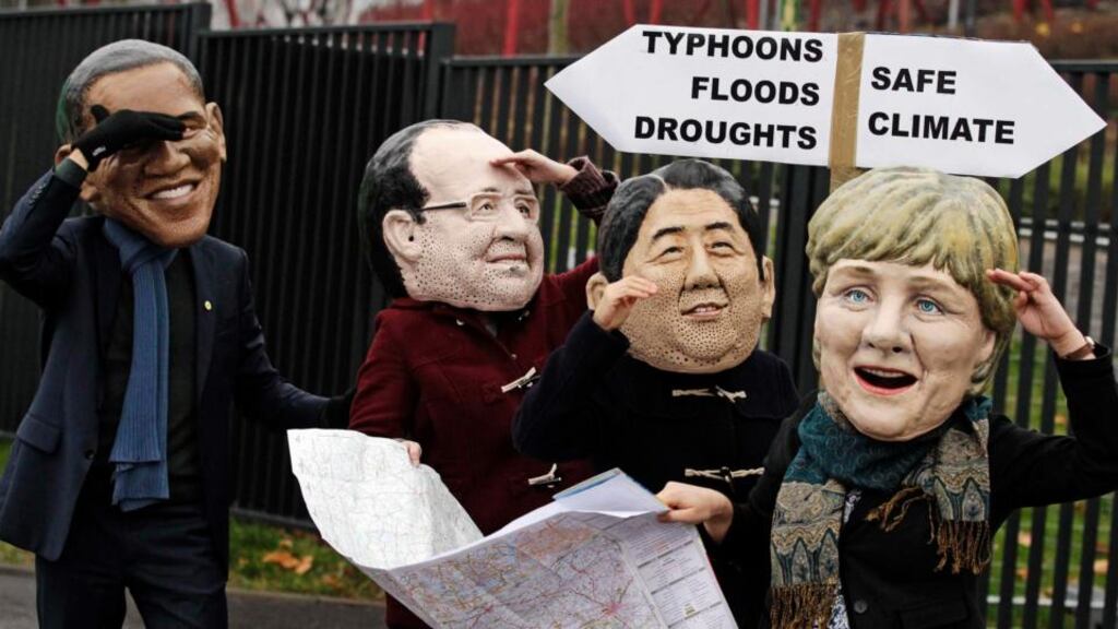 Protesters wearing masks of US president Barack Obama, French president François Hollande, Japanese prime minister Shinzo Abe and German chancellor Angela Merkel on the last day of the 19th conference of the UN Framework Convention on Climate Change in Warsaw yesterday. Photograph: Kacper Pempel/Reuters