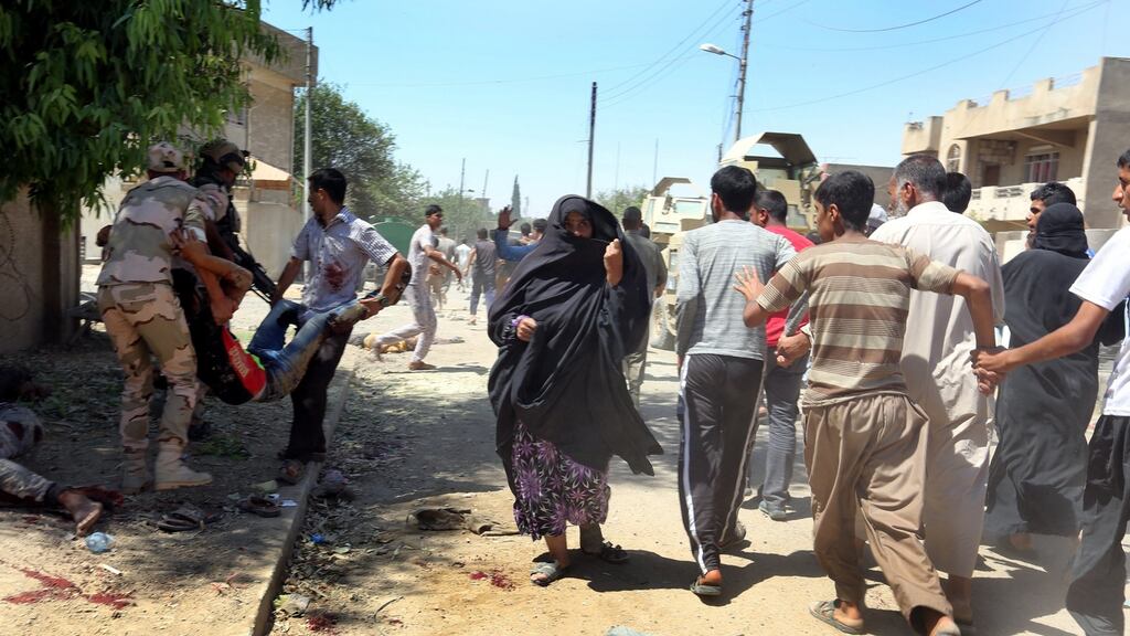 Civilians flee  as Iraqi soldiers evacuate  wounded people  after  a mortar believed to have been  fired by Islamic State fighters struck  the al-Oraibi district of western Mosul, Iraq,  June 3rd, 2017. Photograph: Ahmed Jalil/EPA
