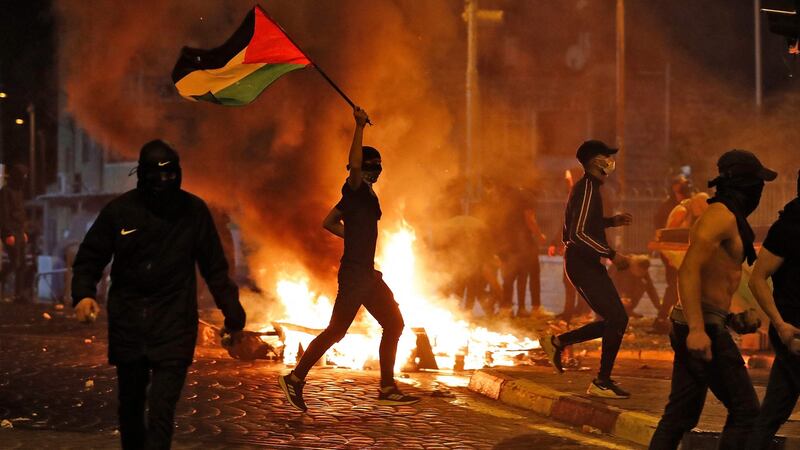 Palestinian protesters hurl stones during clashes with Israeli forces in the Shuafat camp for Palestinian refugees in East Jerusalem. Photograph: Ahmad Gharabli/AFP via Getty