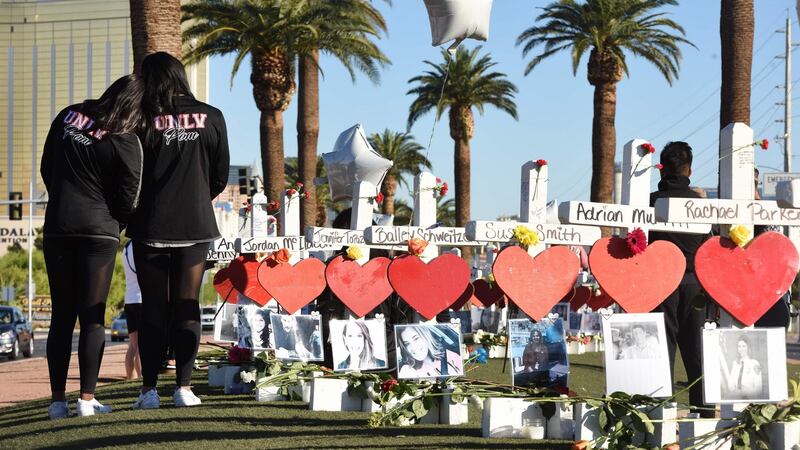 Members of the University of Las Vegas pom squad visit 58 white crosses for the victims of the attack. Photograph: Robyn Beck/AFP/Getty Images
