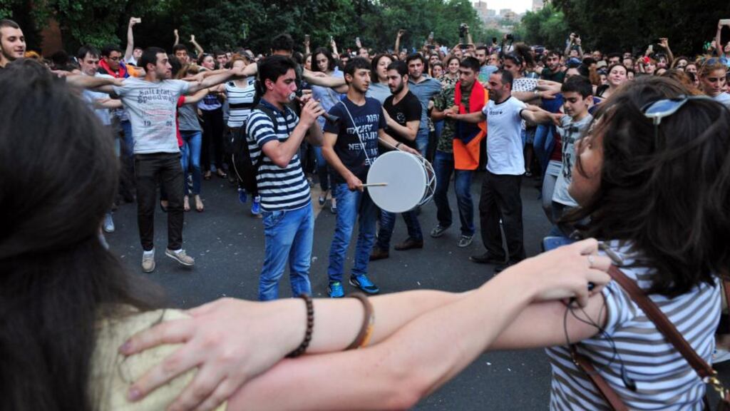 Armenian demonstrators dance on a street during a protest against an increase of electricity prices in Yerevan. Photograph: Karen Minasyan/AFP/Getty Images