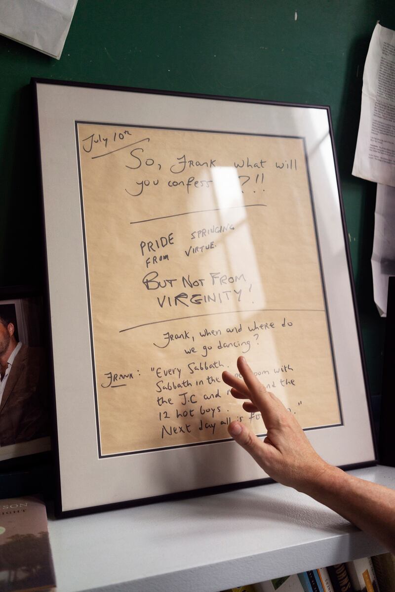 Colum McCann gestures to framed words from his friend Frank McCourt. Photograph: Jillian Freyer/New York Times