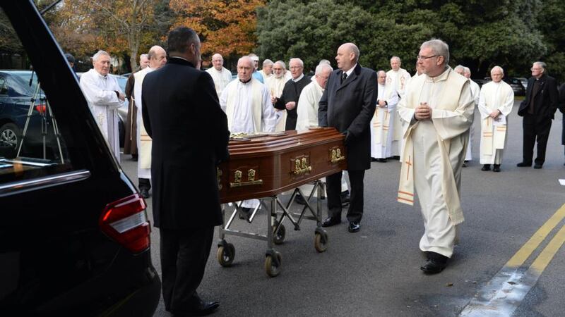 The remains of Fr Alec Reid are taken from the Marianella after the thanksgiving mass. Photograph: Cyril Byrne / The Irish Times.