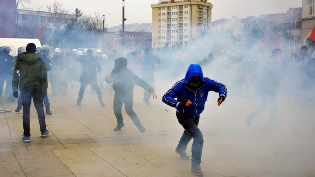 Kosovo police officers fire tear gas during clashes at a demonstration in Pristina, Kosovo on Tuesday. Photograph: EPA/STRINGER