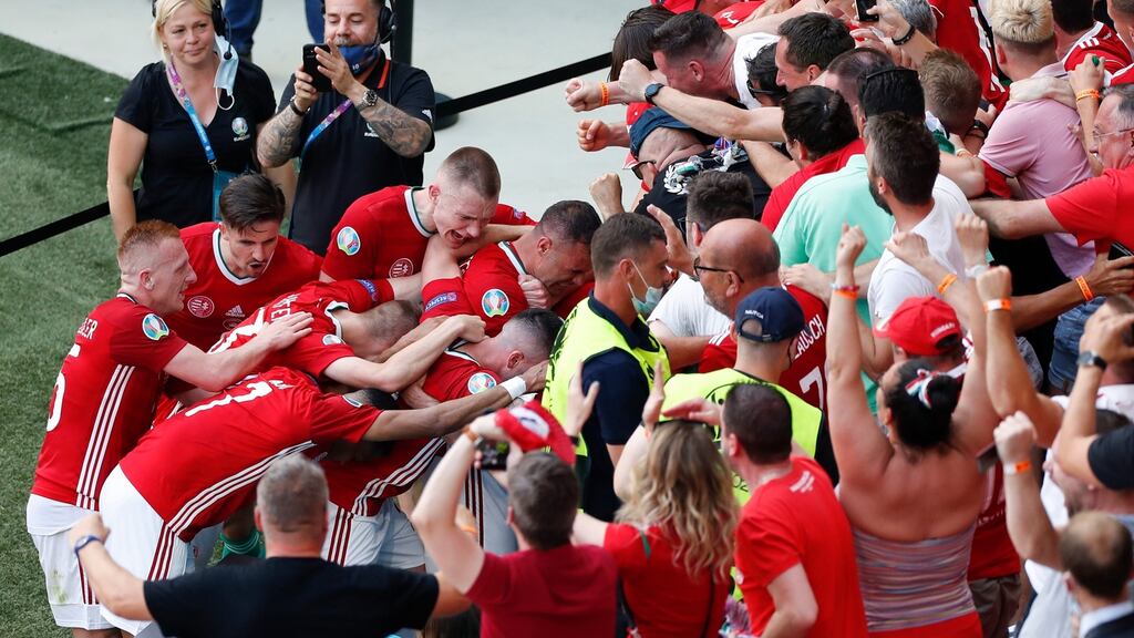 Hungary players congratulate team-mate Attila Fiola  after he scored against France at the Ferenc Puskas Stadium in Budapest. Photograph: Laszlo Balogh/Pool