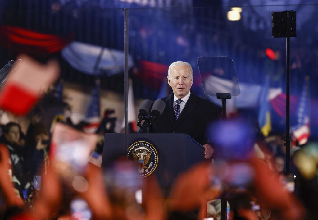 Spectators wave flags as US president Joe Biden delivers a speech at the Royal Warsaw Castle Gardens in Warsaw. Photograph: Wojtek Radwanski/AFP