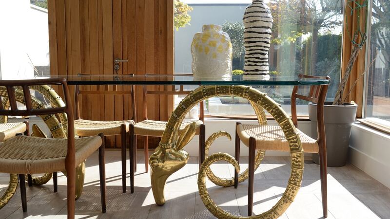 Glass-topped ibex dining table supported by brass rams’ heads. Photograph: Dara Mac Dónaill