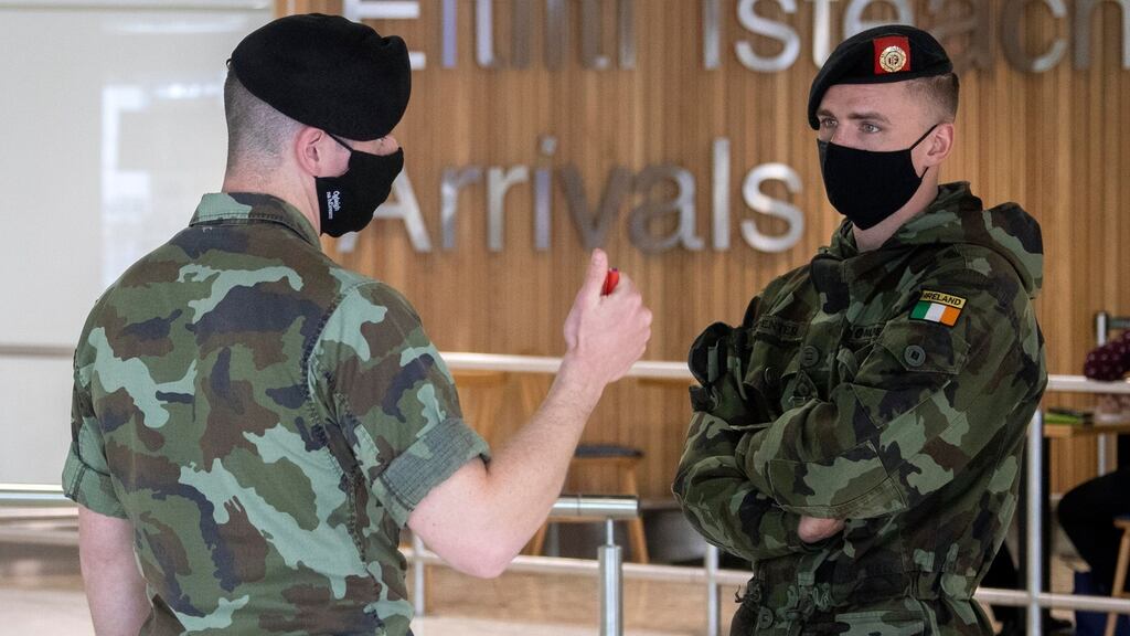 Members of the Defence Forces await passengers in order to enforce Covid-19 mandatory quarantine measures, at Dublin Airport. Photograph: Colin Keegan/Collins