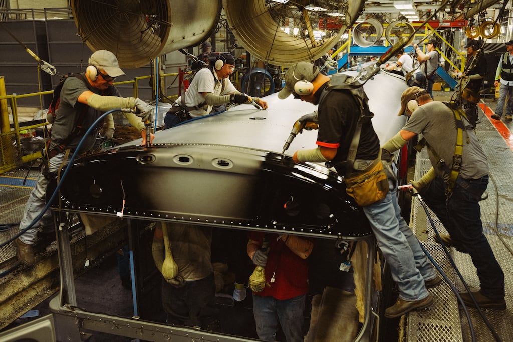 An electric school bus assembly floor in Oklahoma. The green transition will inevitably lead to disruption. Photograph: Mason Trinca/New York Times