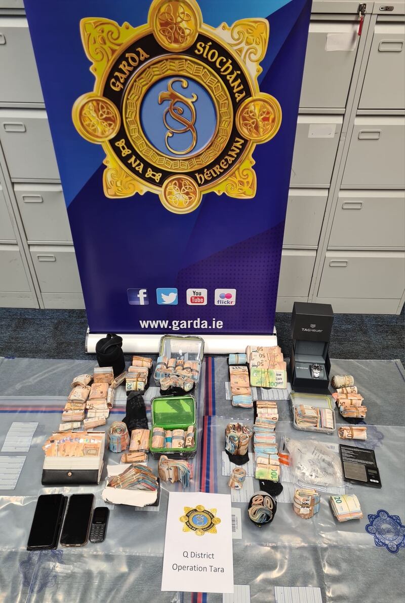 Gardaí from the Drugs Unit in Ronanstown seized cash in excess of €180,000, a designer watch valued at €10,000 and several mobile phones following their search of a property. Photograph: An Garda Síochána