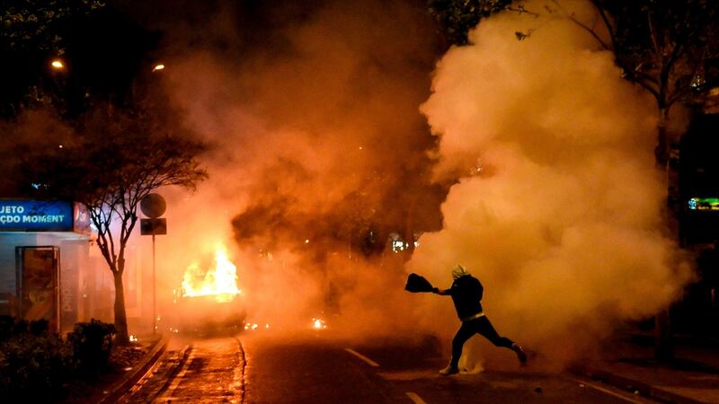 A vehicle ablaze during anti-government protests in the Albanian capital Tirana on Saturday. Photograph: Gent Shkullaku/Getty
