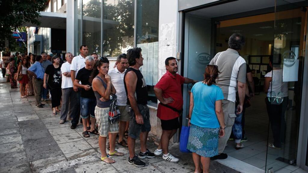 A long line of jobseekers prepare to enter a Labour Force Employment Organisation (OAED) job centre soon after opening in Athens, Greece. Photograph: Angelos Tzortzinis/Bloomberg