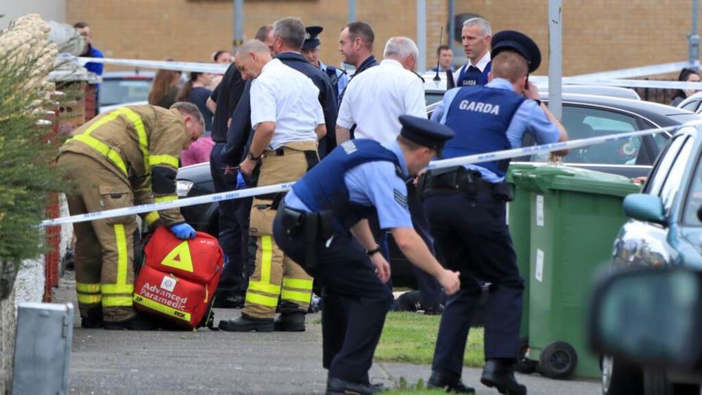 Paramedics tend to a victim at the scene of a shooting on Balbutcher Drive, Ballymun. Photograph: Colin Keegan, Collins Dublin