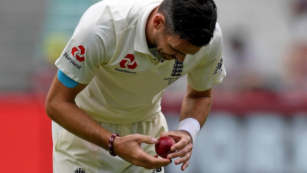 James Anderson of England inspects the ball on day four of the fourth Ashes Test match between England and Australia at the MCG in Melbourne. Photo: Joe Castro/EPA