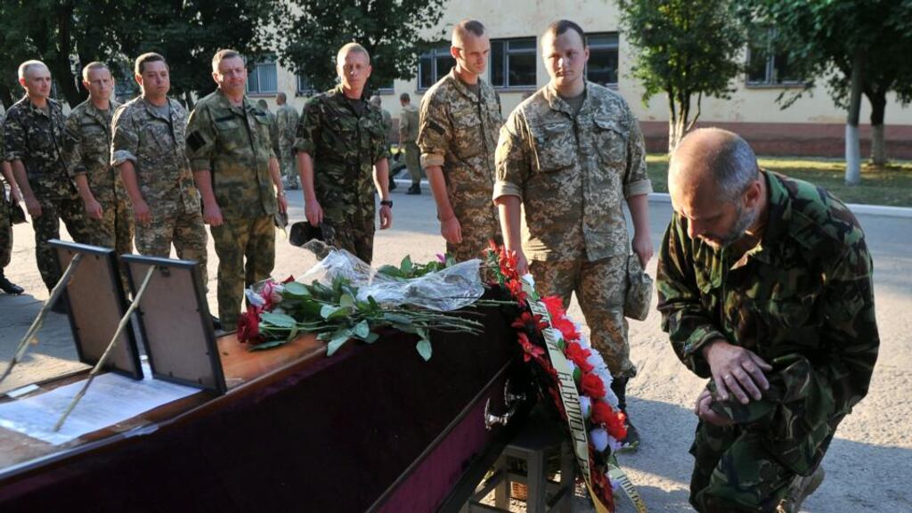 Ukrainian army members pay their repects to a fellow serviceman during his funeral ceremony in Kharkiv. Photograph: Sofia Bobok/AFP/Getty Images