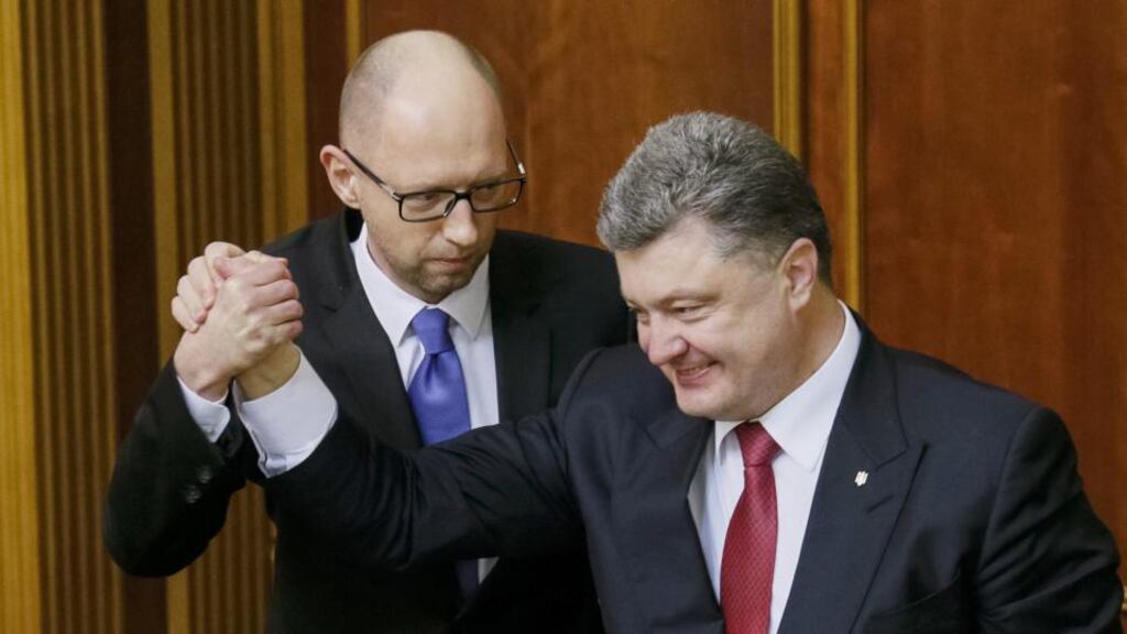 Ukraine’s president Petro Poroshenko (right) congratulates newly-appointed prime minister Arseny Yatseniuk during a parliament session in Kiev on Thursday. Photograph: Reuters/Gleb Garanich