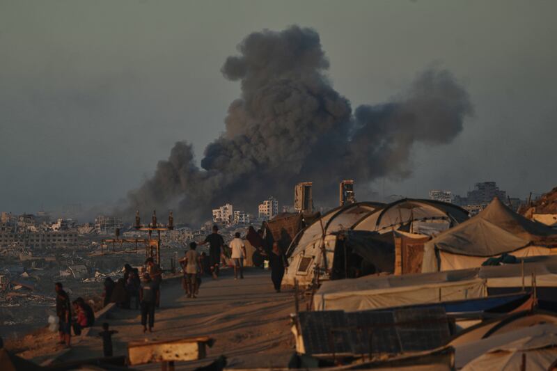 Smoke rises following an Israeli military strike in Gaza City, as seen from the central Gaza Strip. Photograph: Abdel Kareem Hana/AP