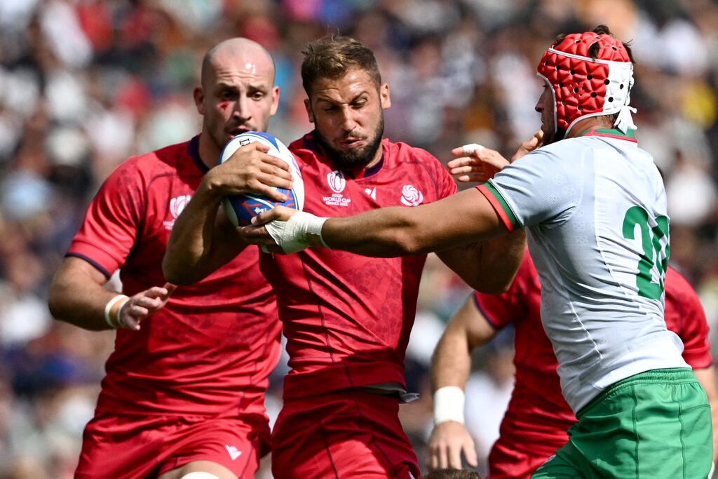 Georgia's centre Demur Tapladze is tackled as he runs with the ball. Photograph: Lionel Bonaventure/AFP via Getty