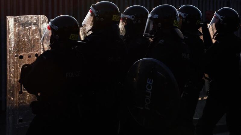 Police officers stand behind their riot shields during a clash with loyalists in the Woodvale Road area of North Belfast. Photograph: Cathal McNaughton/Reuters.