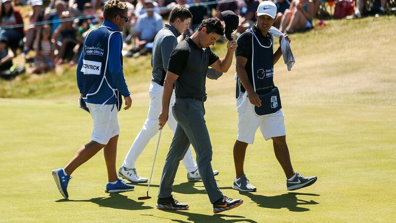 McIlroy salutes the crowd after finishing his round on the 9th. Photo: Oisin Keniry/Inpho