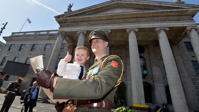 Capt Paul Conlon with his son Senan (3) after reading the Proclamation during an event at the GPO marking the 103rd anniversary of the Rising. Photograph: Alan Betson/The Irish Times