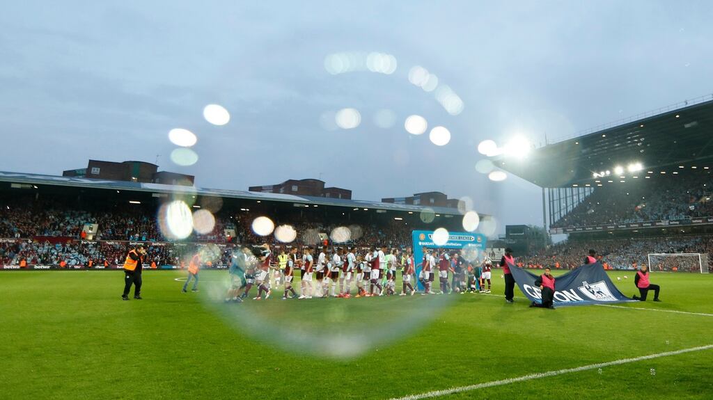 A bubble floats acros the camera lens as West Ham and Manchester United players shake hands ahead of the final Premier League game to be played at Upton Park. Photograph: Eddie Keogh/Reuters/Livepic