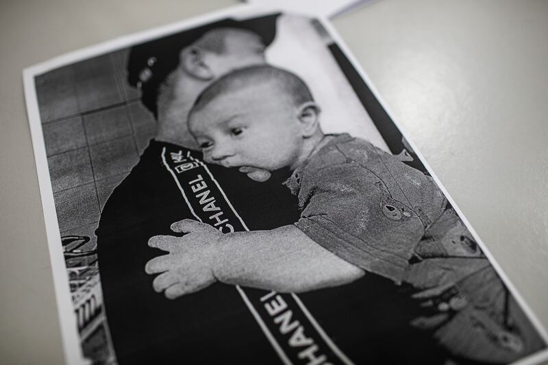 Xu Wenjun with his son, who was birthed by surrogate Hun Daneth, taken before Wenjun was imprisoned for human trafficking, in Phnom Penh. Photograph: Nadia Shira Cohen/The New York Times