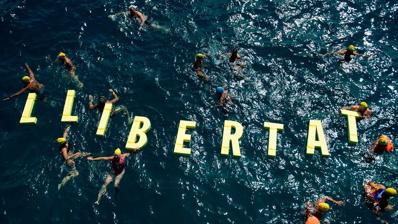 People swim around floating letters forming the word “Freedom” in Catalan during a pro-independence gathering in Badalona, close to Barcelona. Photograph: Josep Lago/AFP