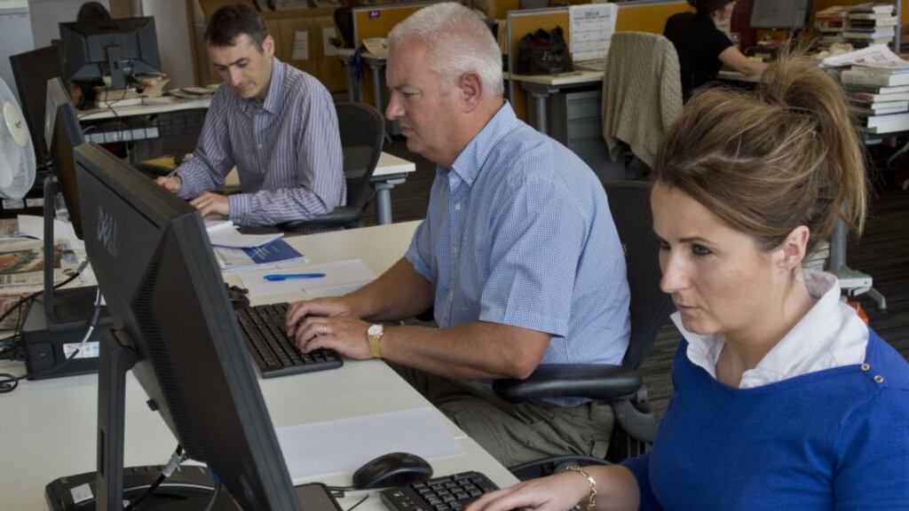 Brian Howard and Deirdre Garrett answering queries on the ‘The Irish Times’ Results Helpdesk this year, with Education Correspondent Joe Humphreys in the background. Photograph: Brenda Fitzsimons