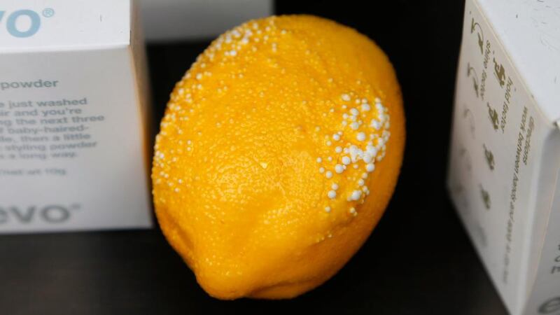 A damaged lemon is seen in the window of a nearby barbers shop. Photograph: Stefan Wermuth/Reuters