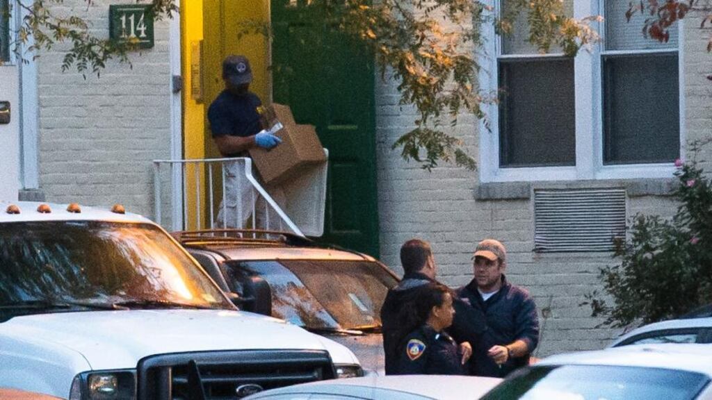 A federal agent removes evidence yesterday from the apartment complex where Miriam Carey is believed to have lived in Stamford, Connecticut. Photograph: AP Photo/John Minchillo