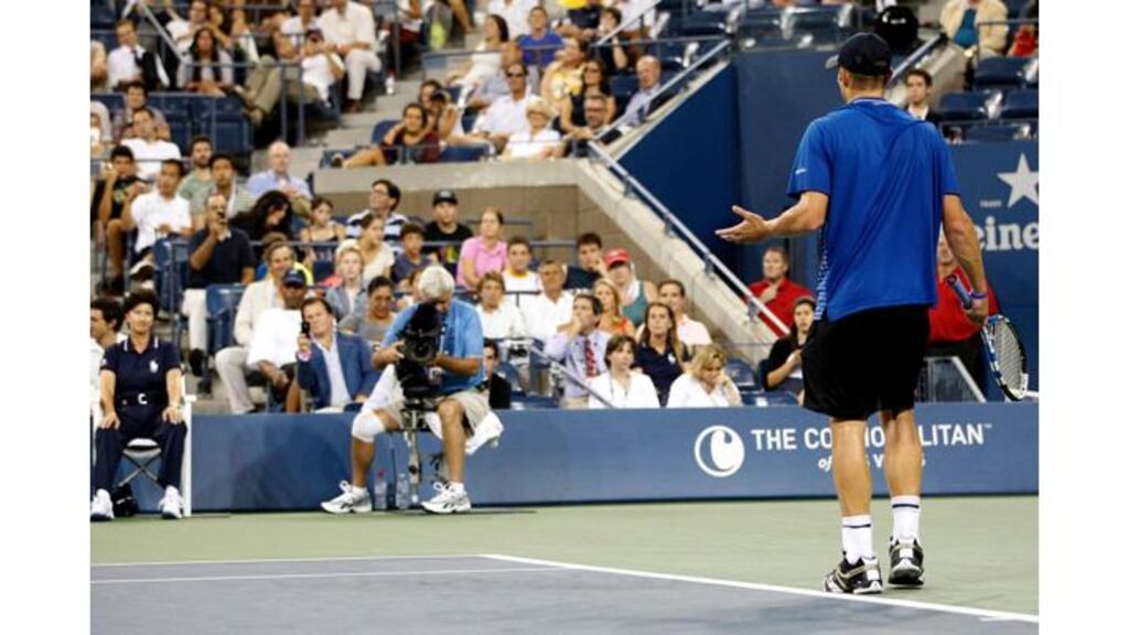 Andy Roddick contests a decision with the line judge after being called for a foot fault in the third set. Photograph: Shannon Stapleton/Reuters
